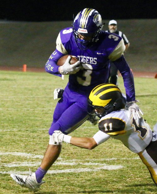 Lemoore's Brandon Hargrove breaks a tackle by Golden West's Jose Luis Ramos Friday night in Tiger Stadium.
